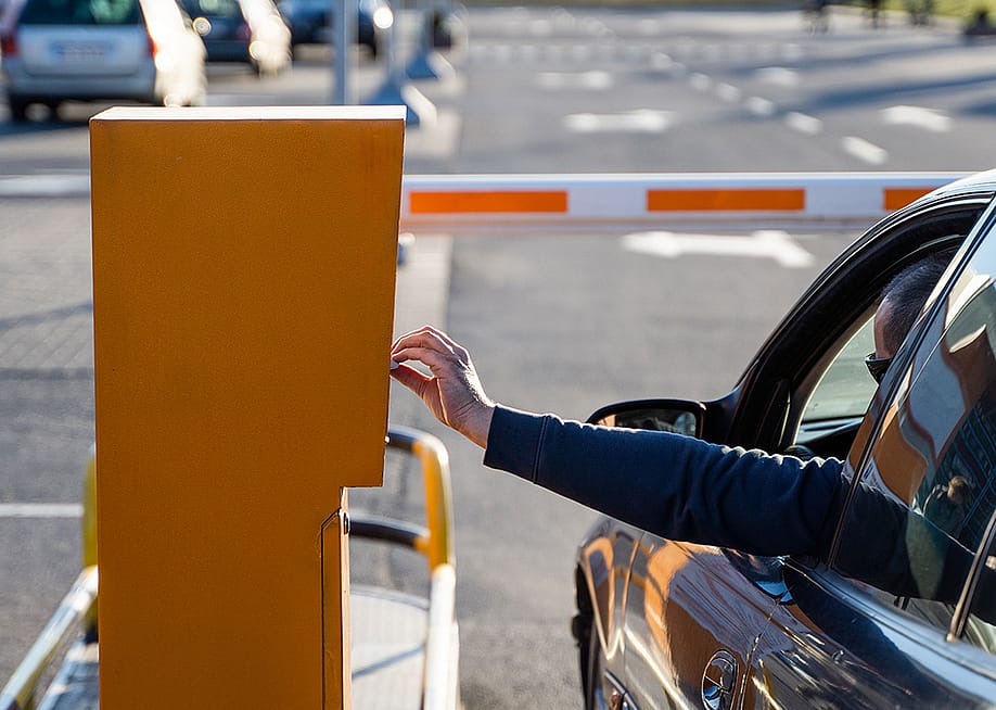 Person in the car paying for a parking ticket. — Volodymyr_Shtun // Shutterstock