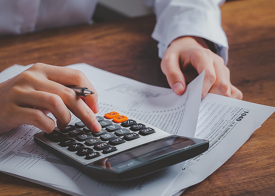 Business person calculating taxes. — KT Stock photos // Shutterstock