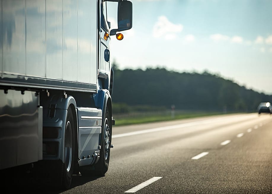 Long moving truck on a highway. — CatwalkPhotos // Shutterstock.