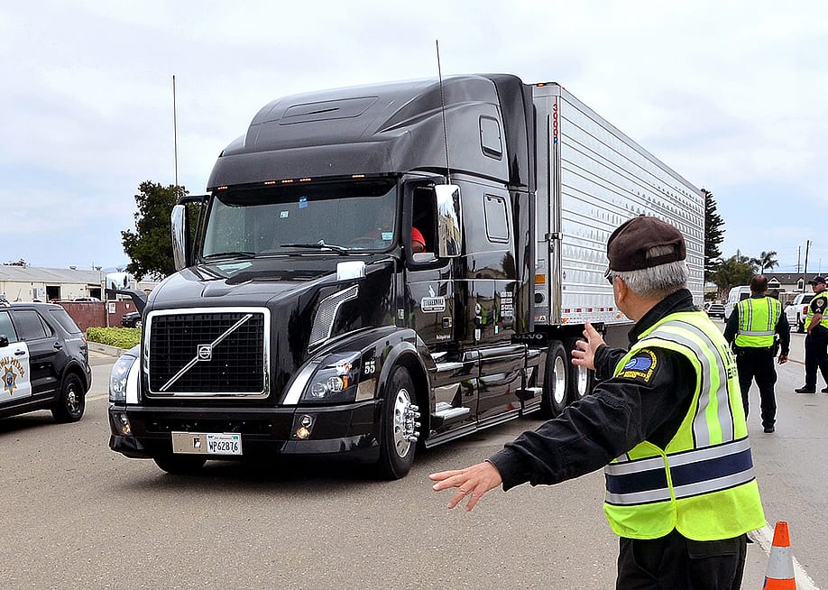 A big rig being pulled over by inspectors during a surprise inspection in Santa Monica, California. — Bill Morson // Shutterstock