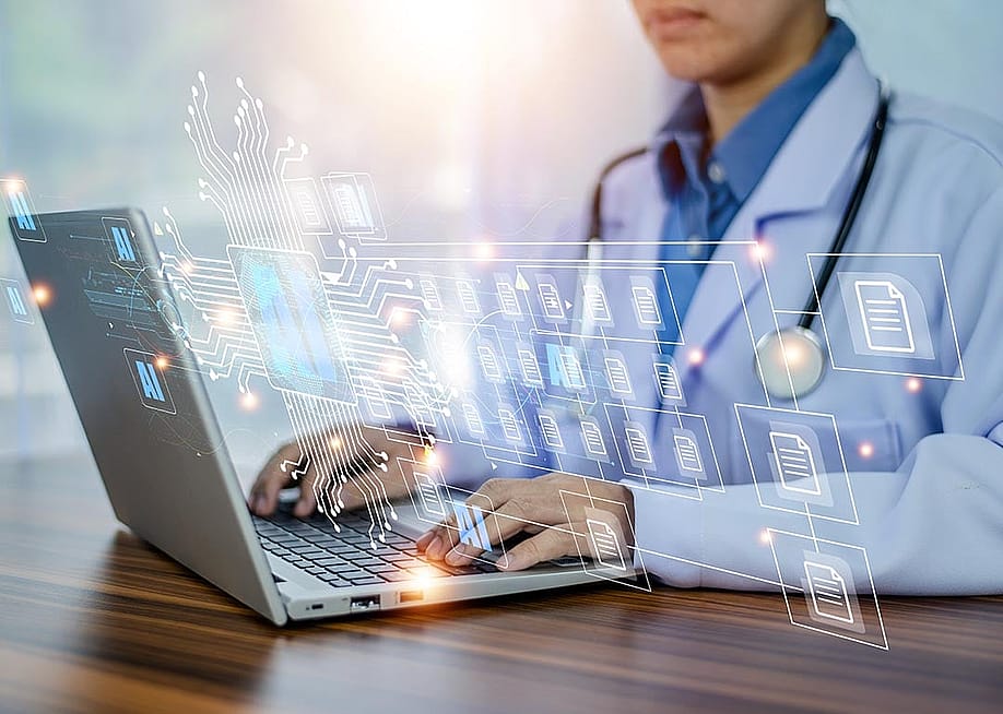 Concept of doctors using AI illustrated with medical professional with white coat and stethoscope using laptop computer with AI icons and symbols overlaid. — MUNGKHOOD STUDIO // Shutterstock