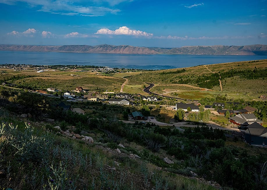 A view of Bear Lake with mountains in the distance with hills and homes in the foreground from July 2024. — Rick Egan // The Salt Lake Tribune
