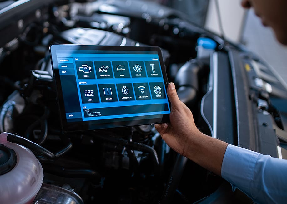 Car mechanic using a tablet to diagnose a car's components' issues. — Gorodenkoff // Shutterstock