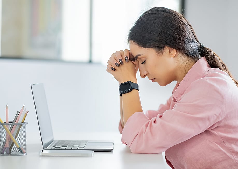 Young professional having a headache at work. — Prostock-studio // Shutterstock