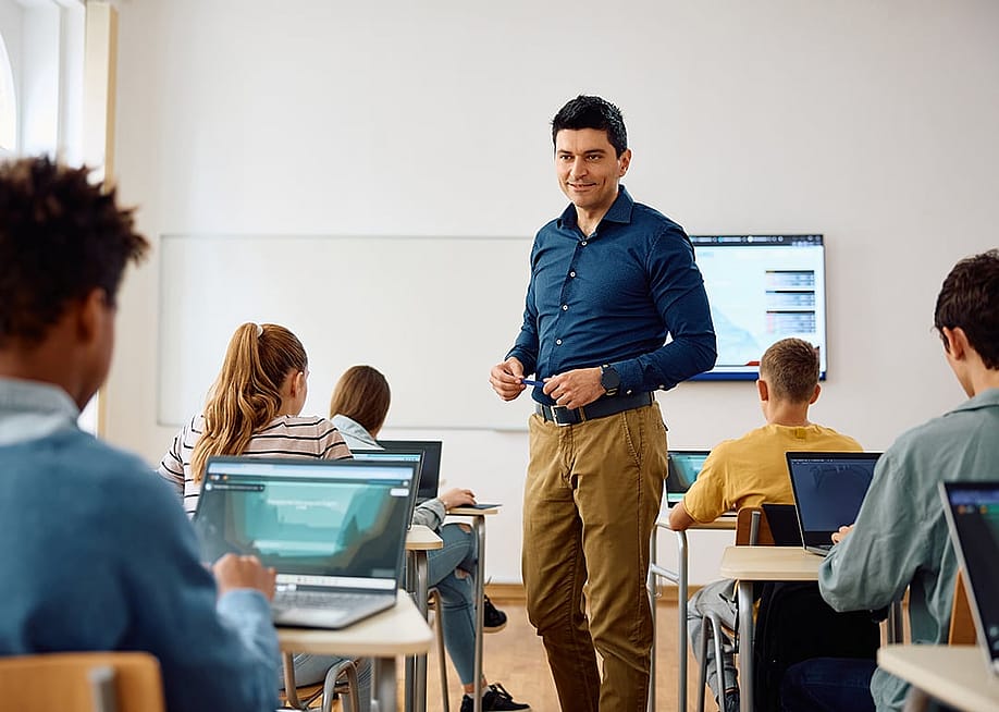 A high school teacher in the middle of his class. — Drazen Zigic // Shutterstock