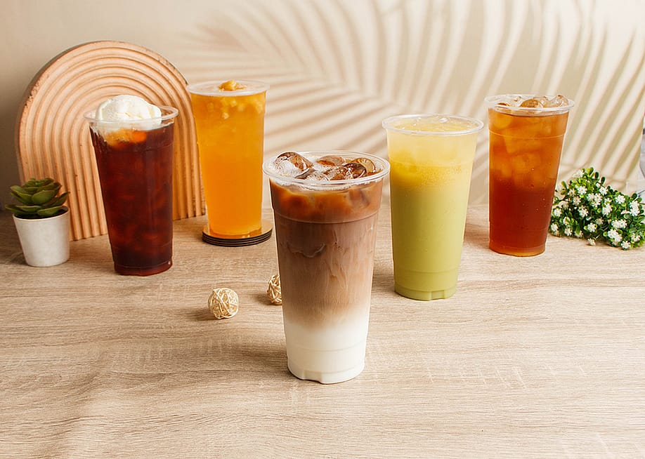 Assorted summer drinks such as coffee, milk tea, and fruit juice drinks. — Food Shop // Shutterstock