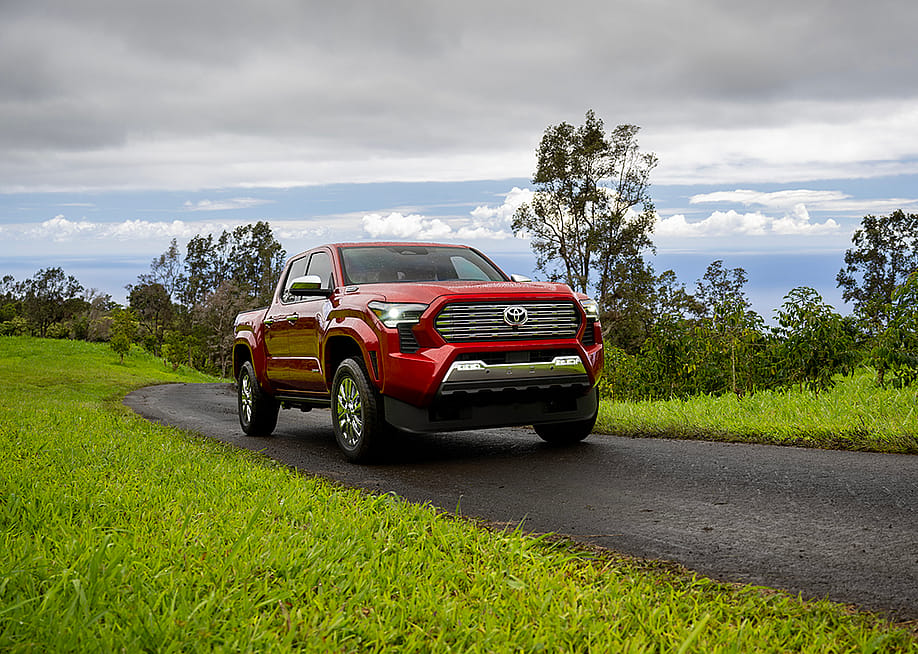 A red 2025 Toyota Tacoma on the road. — Toyota
