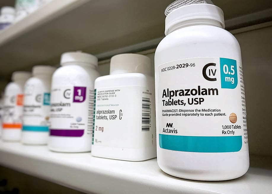 Bottles of Alprazolam bottle on a shelf. — PureRadiancePhoto // Shutterstock