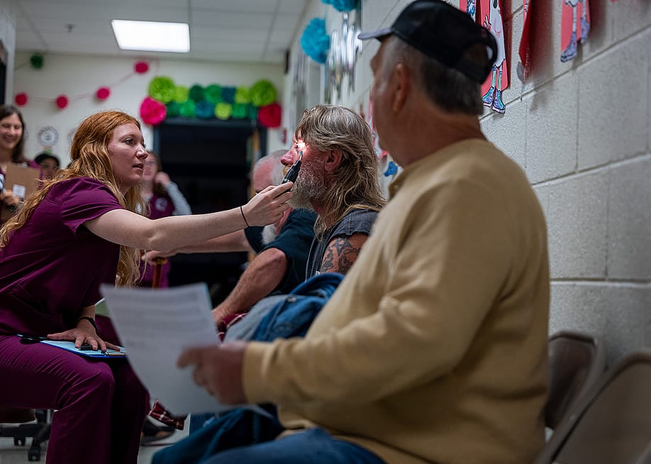 Optometry students administer vision tests to patients at a mobile dental and medical clinic in Grundy, Virginia. — Spencer Platt // Getty Images