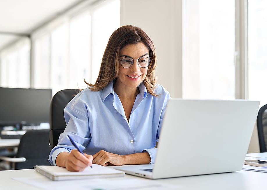 Middle-aged businesswoman working in a corporate office. — insta_photos // Shutterstock