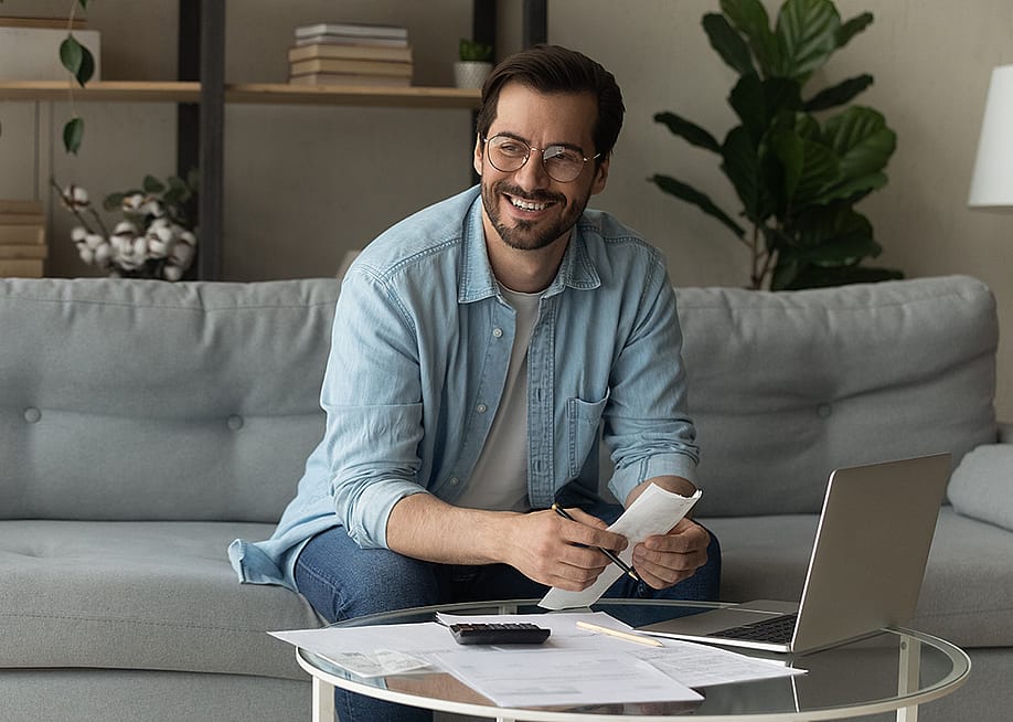 Happy man holding credit documents. — fizkes // Shutterstock