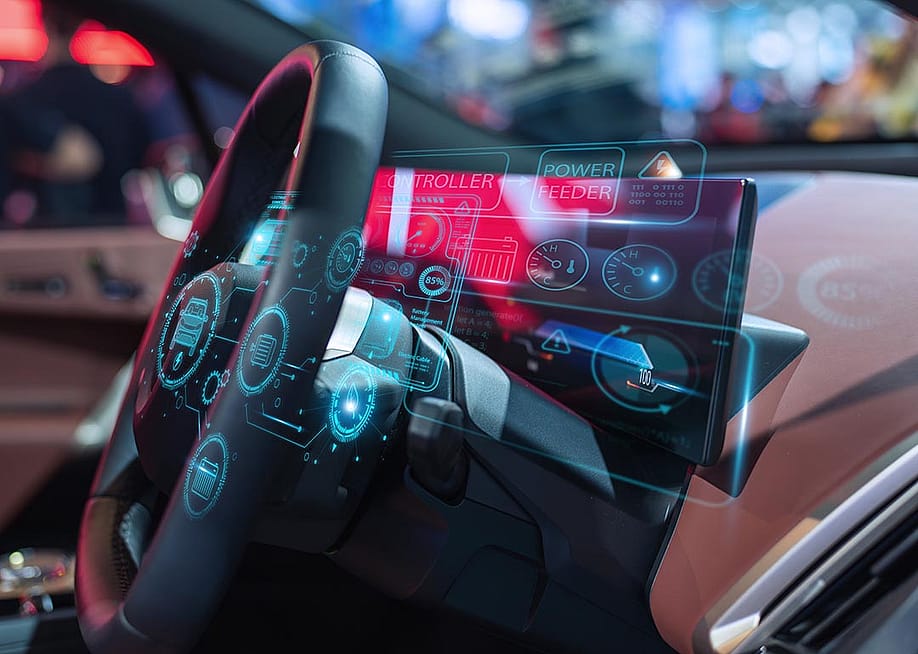 Close-up of a futuristic car dashboard featuring a digital interface with holographic displays and advanced controls. — CC7 // Shutterstock
