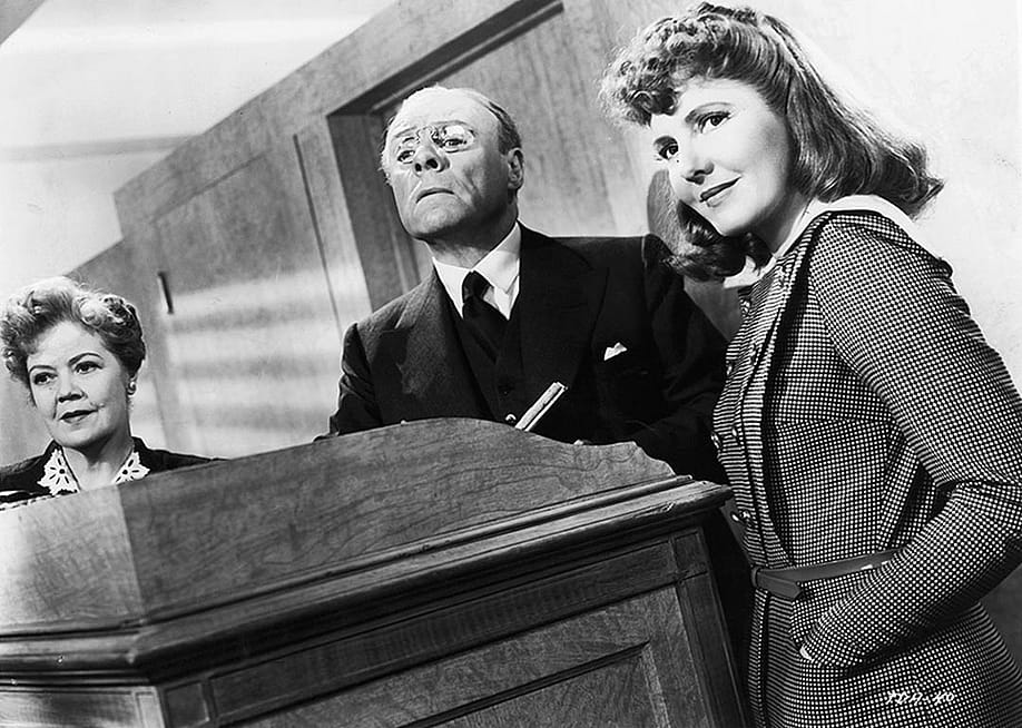 Black and white image of Spring Byington, unidentified man, and Jean Arthur in a scene from the film 'The Devil And Miss Jones', 1941. — RKO Radio Pictures // Getty Images