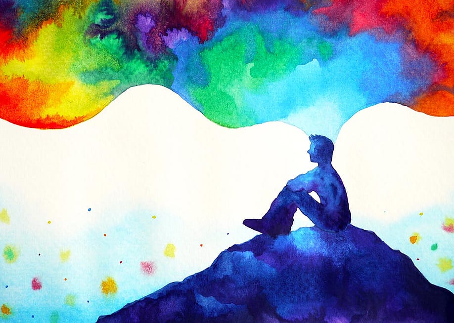 Abstract art watercolor painting illustration of person sitting on a hill with thoughts depicted in rainbow clouds floating above. — Benjavisa Ruangvaree Art // Shutterstock