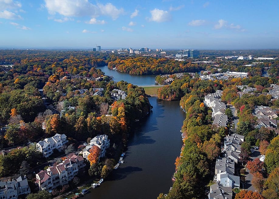 Aerial view of colorful fall trees surround lakes and homes in Fairfax County, Virginia. — Kevin Capretti // Shutterstock