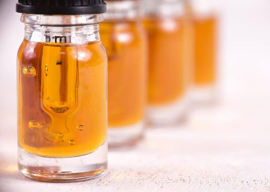 Macro detail of dropper with CBD oil, cannabis live resin extraction isolated on white background. — Roxana Gonzalez // Shutterstock