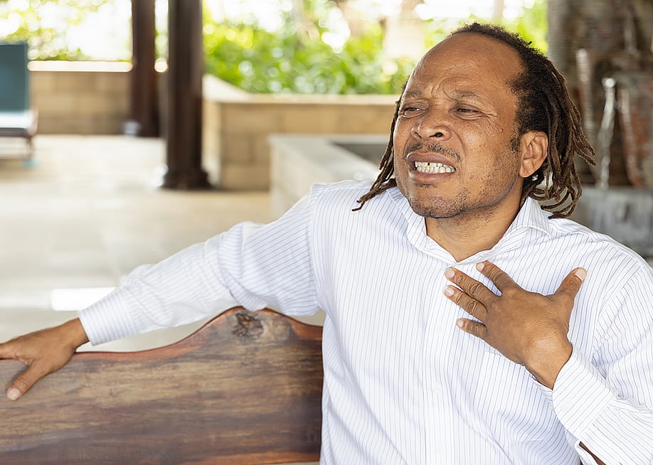 A middle-aged man suffering from acid reflux. — 9nong // Shutterstock