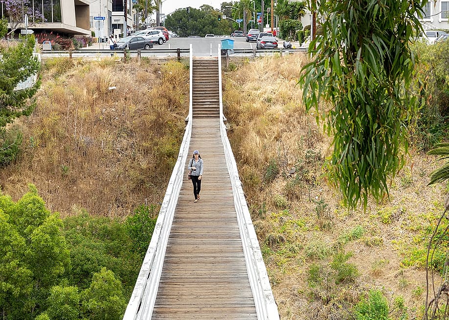 A woman walking across the Quince Street Bridge in Banker's Hills in San Diego, California. — The Image Party // Shutterstock