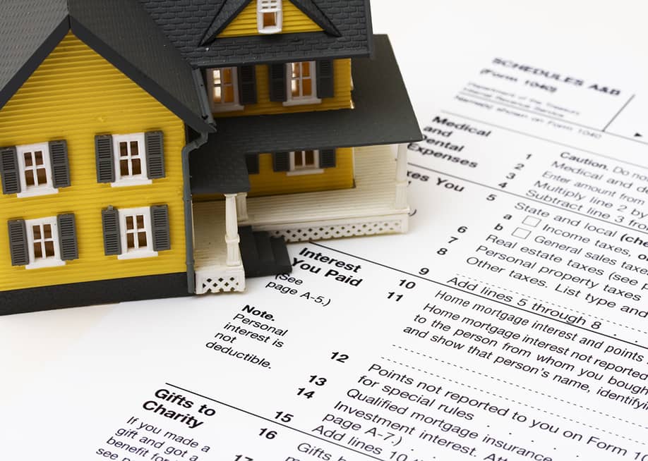 A figure of a house on a U.S. tax form. — karen roach // Shutterstock