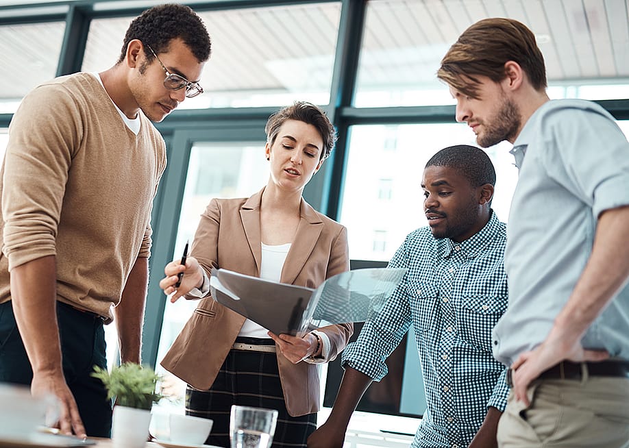 A creative team in an office analyzing expense management reports. — PeopleImages.com - Yuri A // Shutterstock