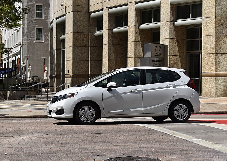 A white Honda Fit EX-L FWD car in downtown Houston, Texas. — Artistic Operations // Shutterstock