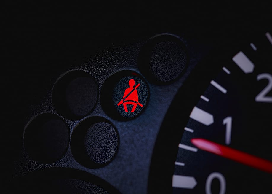 A car's dashboard with the seatbelt warning light turned on. — Pamela Au // Shutterstock