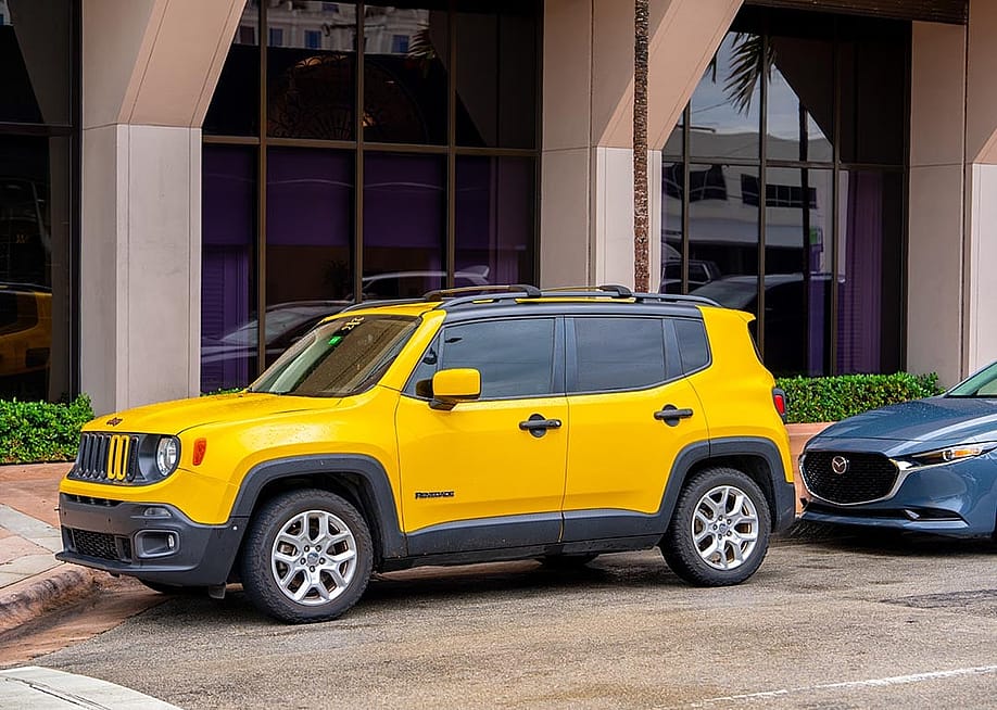Yellow Jeep Renegade SUV parked in FL. — Felix Mizioznikov // Shutterstock