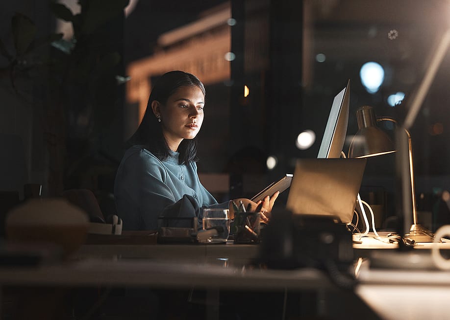 A businesswoman working in office at night. — PeopleImages.com - Yuri A // Shutterstock