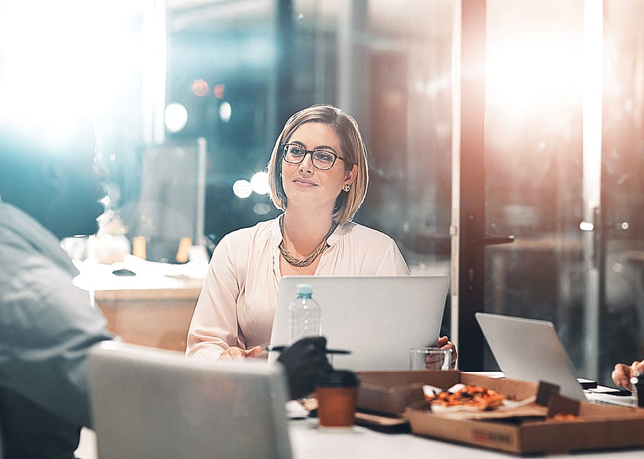 A business leader in a late night team meeting. — PeopleImages.com - Yuri A // Shutterstock