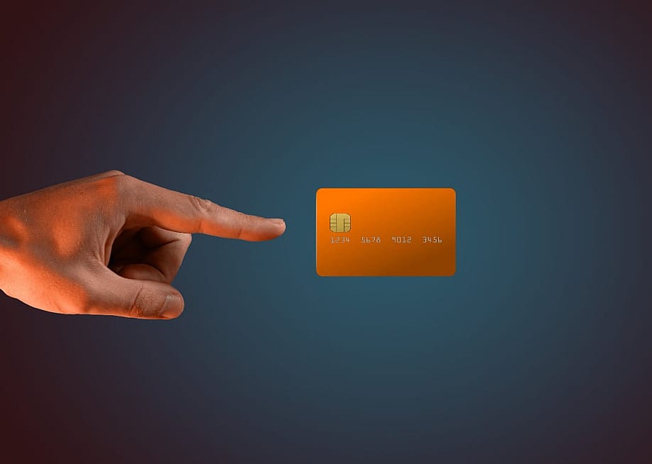 A hand levitating a credit card. — Geobor // Shutterstock