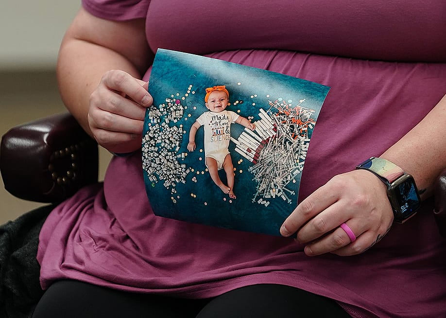 Elizabeth Goldman, an in-vitro fertilization patient at the University of Alabama at Birmingham, holds up a photo of her daughter who was born via the procedure. — Elijah Nouvelage // Getty Images