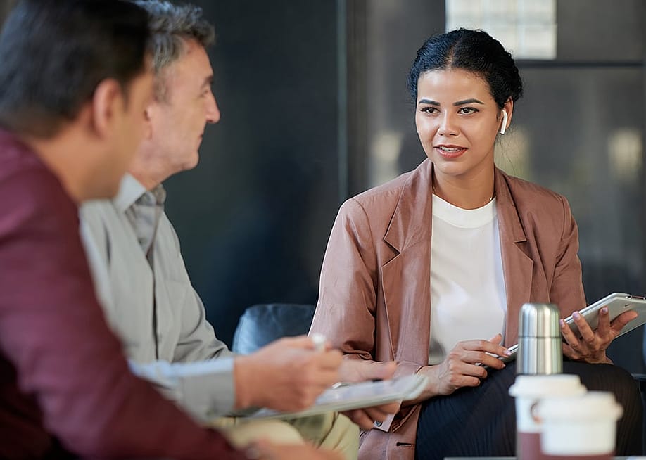 A female chief marketing officer in a meeting with her colleagues. — Dragon Images // Shutterstock