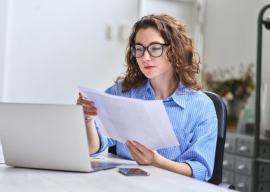 A young businesswoman reading audit reports. — insta_photos // Shutterstock