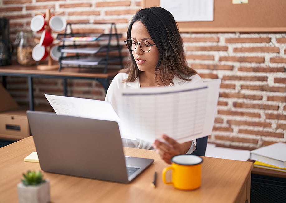 A female business worker looking at business documents. — Krakenimages.com // Shutterstock