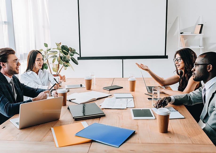 A diverse business team having a meeting in their office. — LightField Studios // Shutterstock