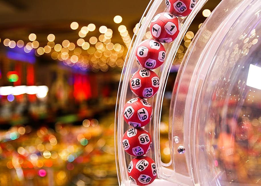 Red lottery balls in a bingo machine in a casino. — Kitsada waisayakul // Shutterstock
