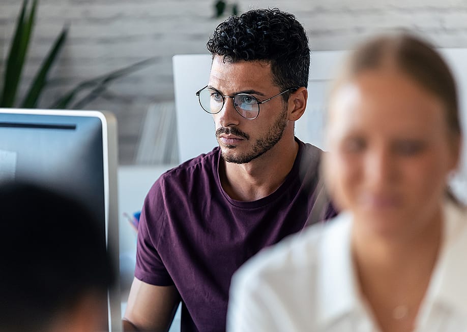Focus shot on a young male entrepreneur working in an office. — Josep Suria // Shutterstock