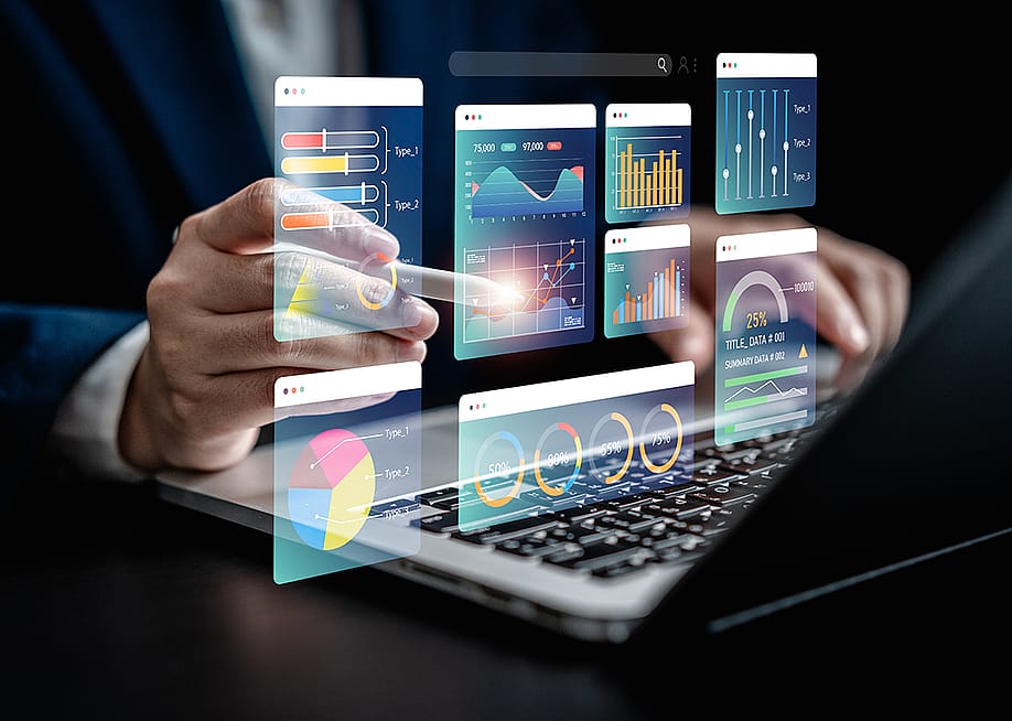 Businessman using a laptop with illustratons of finance software, charts and dashboard graphics. — Gumbariya // Shutterstock