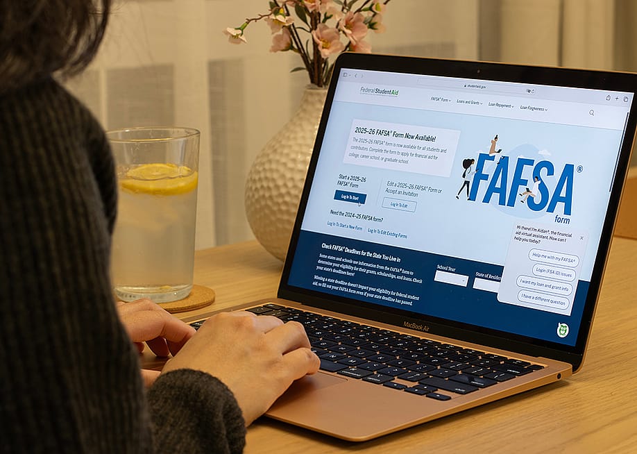 A student browsing the FAFSA website on a laptop. — Tada Images // Shutterstock
