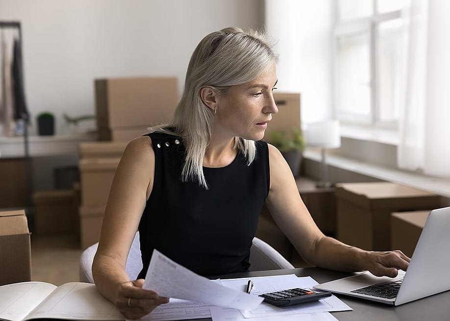 A female business owner reviewing documents in her office. — fizkes // Shutterstock