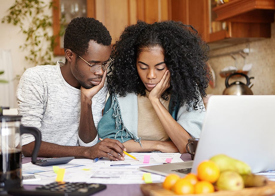 A couple reviews their finances. — Cast Of Thousands // Shutterstock