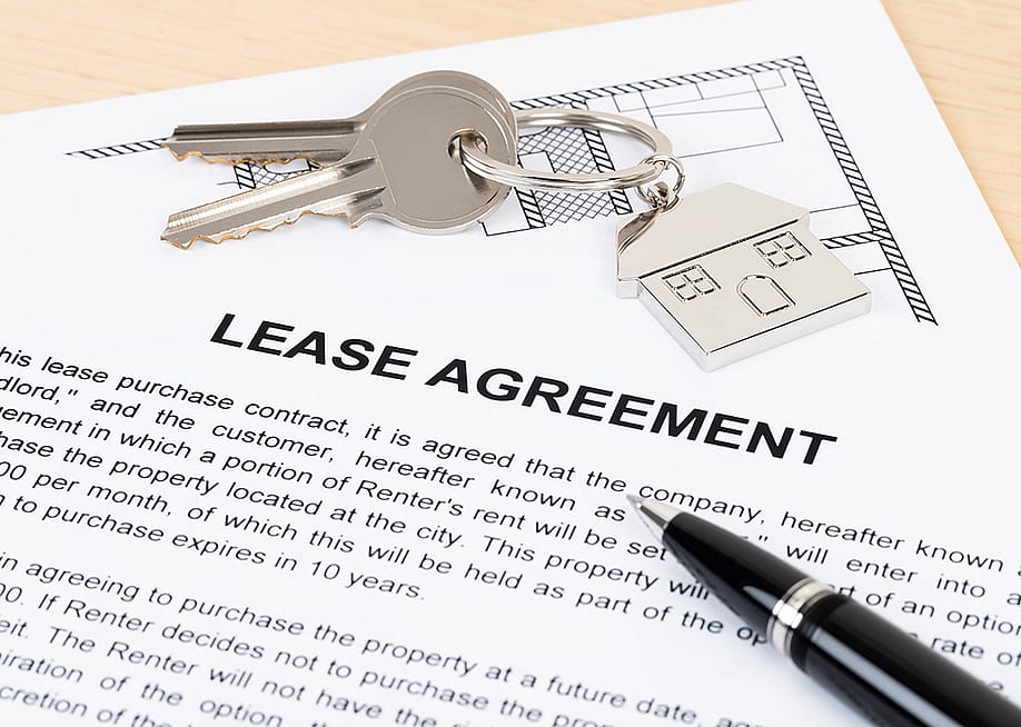 A mock up of a lease agreement document with house keys on top of it. — Casper1774 Studio // Shutterstock