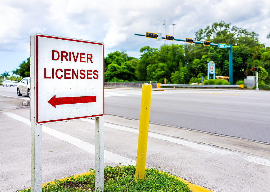 A roadside sign showing direction to a driver's license office. — Andriy Blokhin // Shutterstock