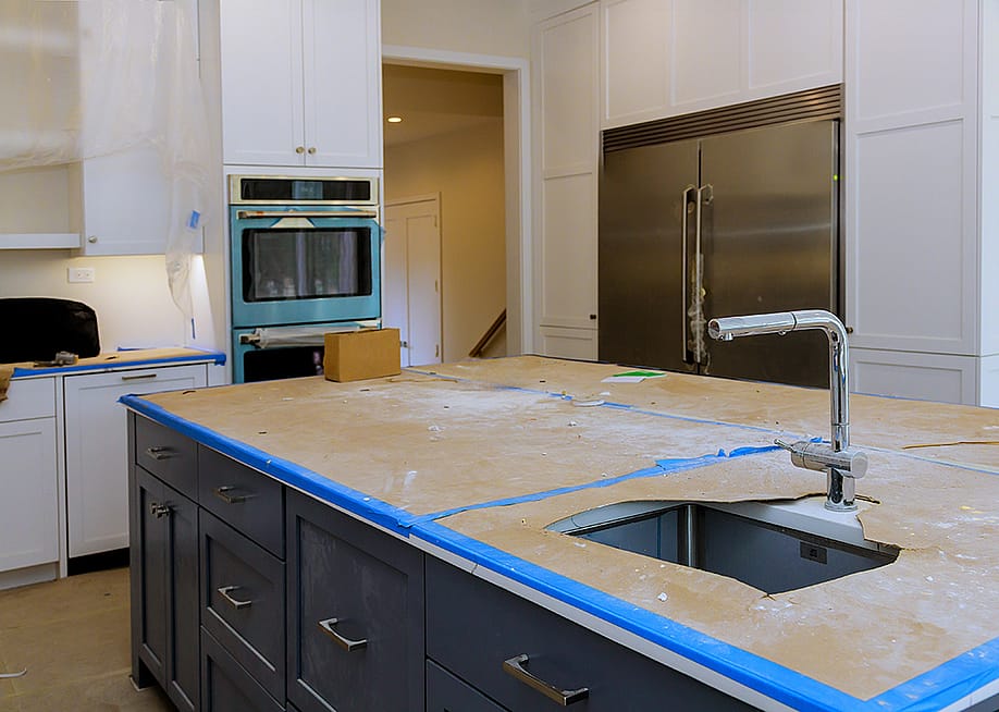 A modern kitchen with a focus on a countertop in progress of renovation. — ungvar // Shutterstock