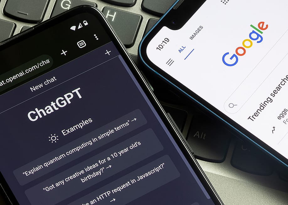 Phones side-by-side with open tabs showing ChatGPT and Google. — Tada Images // Shutterstock