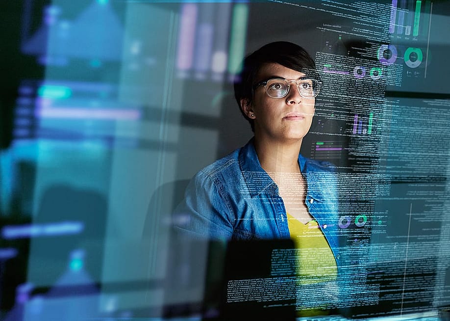 A young female computer programmer looking through data. — PeopleImages // Shutterstock