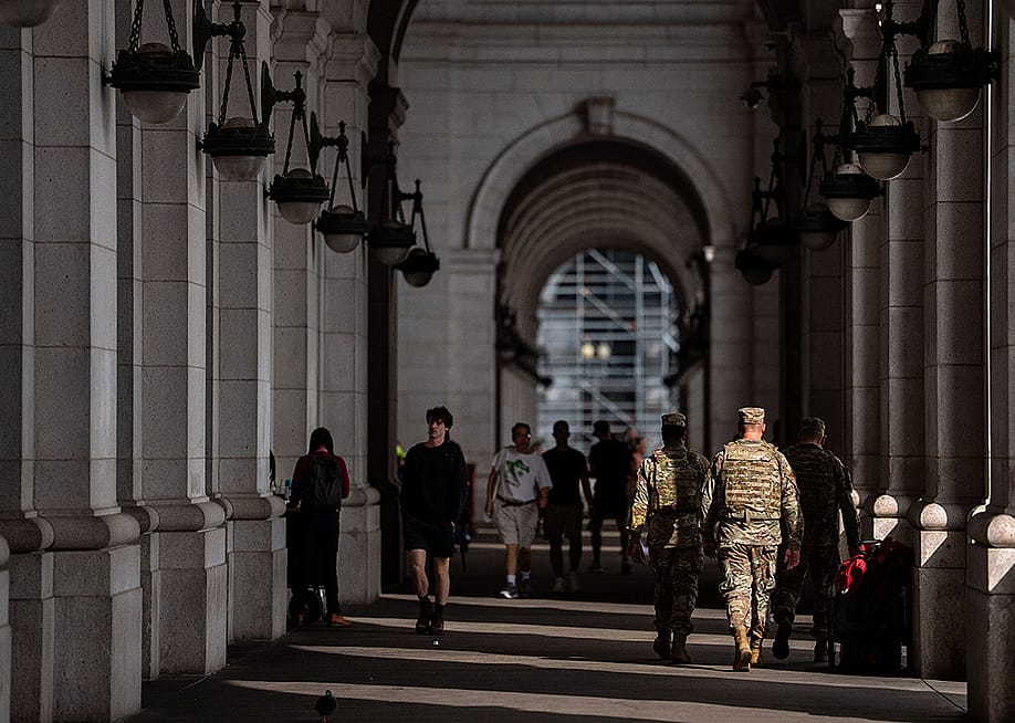 Members of the National Guard and members of Federal Law Enforcement Agencies stand outside the main hall of Union Station in Washington, D.C. — Kent Nishimura // Getty Images