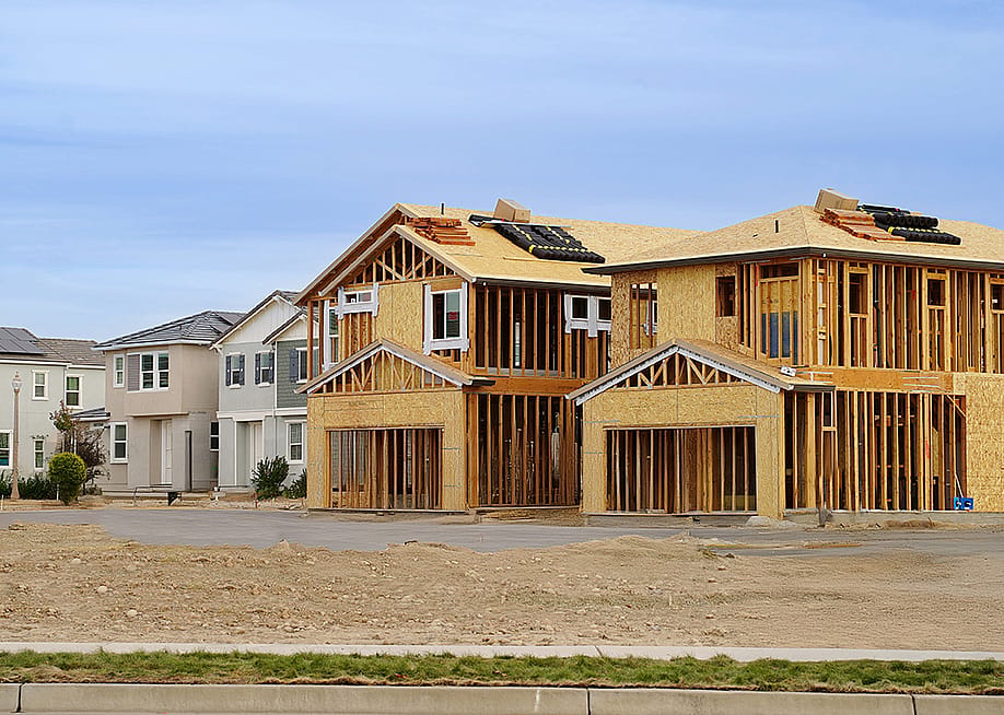 A row of finished homes and a few still under construction. — JazK2 // Shutterstock