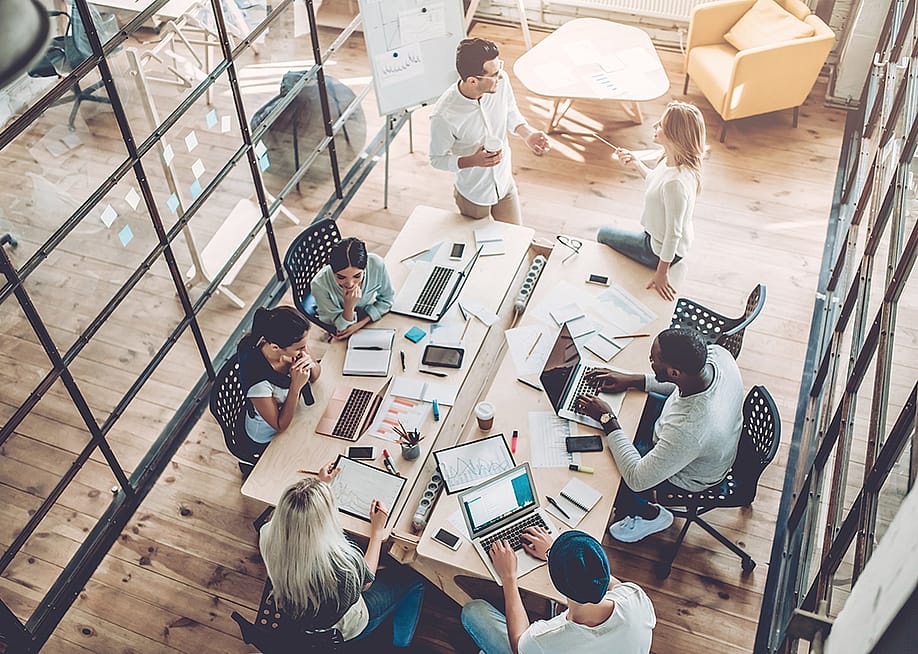High-angle view of a creative business team in a meeting. — 4 PM production // Shutterstock