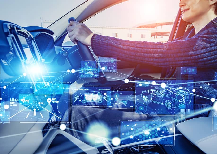 A driver inside a car illustrated with intelligent technology graphics. — metamorworks // Shutterstock